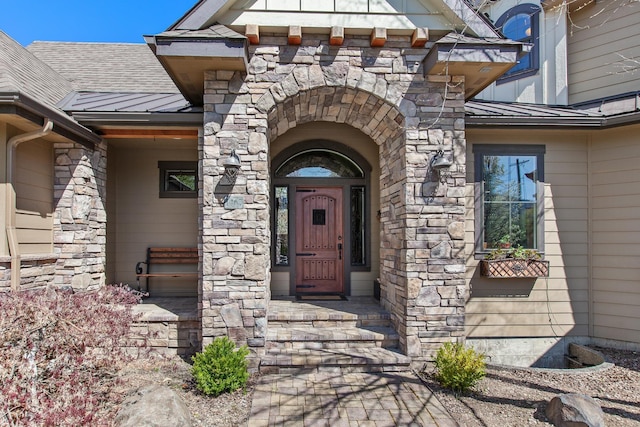 1467 E Lacey Ave, Hayden, ID 83835 - view of exterior entry with a standing seam roof, stone siding, metal roof, and a shingled roof
