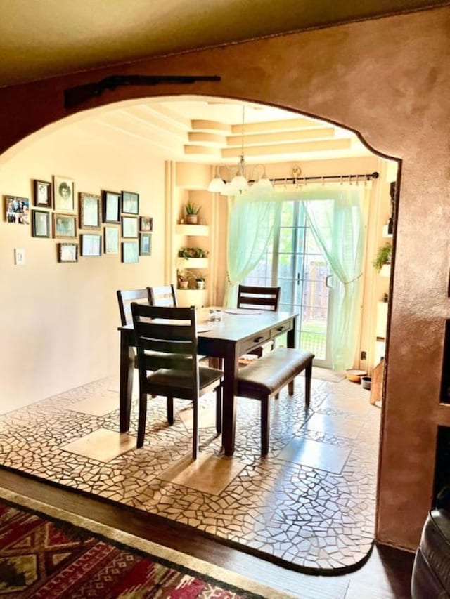 1654 Southshore Diamond Lake Rd, Newport, WA 99156 - dining room with arched walkways, built in features, and a chandelier