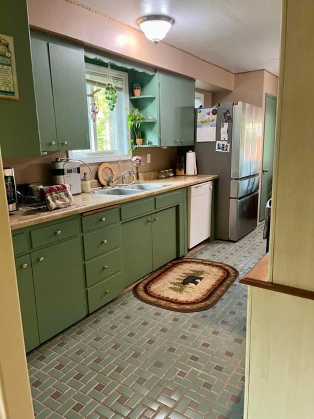 1654 Southshore Diamond Lake Rd, Newport, WA 99156 - kitchen with white dishwasher, a sink, green cabinets, and freestanding refrigerator
