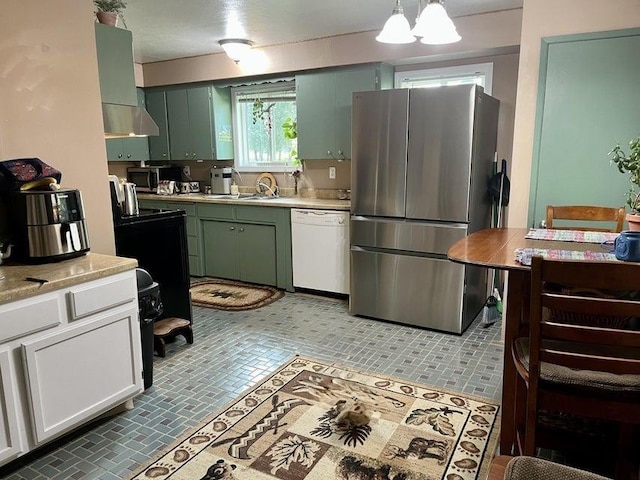 1654 Southshore Diamond Lake Rd, Newport, WA 99156 - kitchen featuring stainless steel appliances, green cabinets, light countertops, a sink, and hanging light fixtures