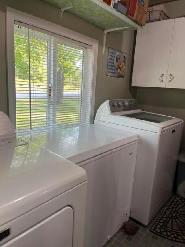 1654 Southshore Diamond Lake Rd, Newport, WA 99156 - laundry room featuring washing machine and clothes dryer, cabinet space, and brick patterned flooring