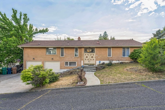 4004 W Taft Dr, Spokane, WA 99208 - view of front of property with a garage, concrete driveway, a chimney, and brick siding