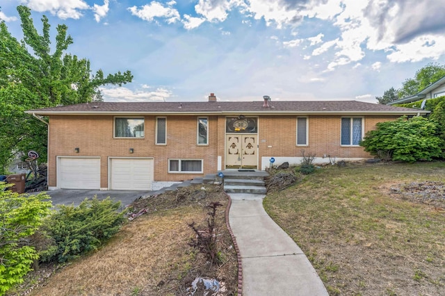 4004 W Taft Dr, Spokane, WA 99208 - view of front of home featuring an attached garage, driveway, brick siding, a front yard, and a chimney