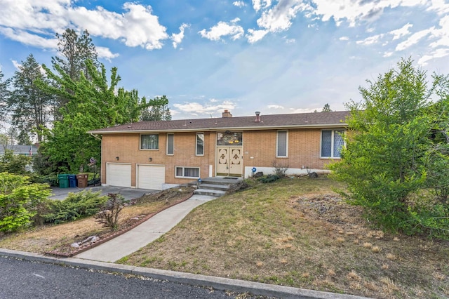 4004 W Taft Dr, Spokane, WA 99208 - view of front of house featuring brick siding, a garage, asphalt driveway, a chimney, and a front yard