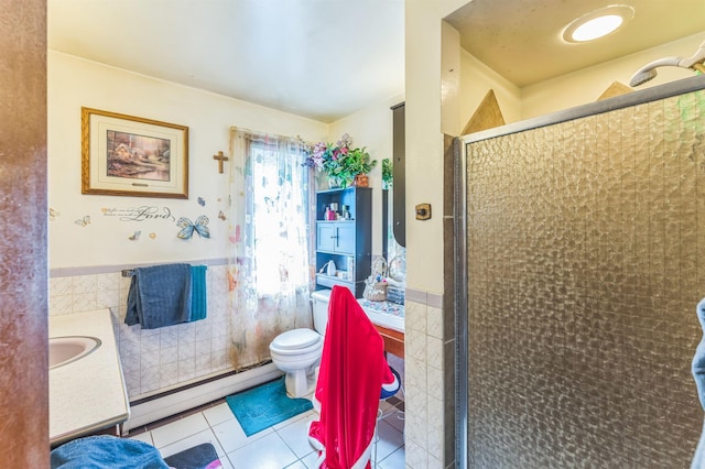 4004 W Taft Dr, Spokane, WA 99208 - bathroom with baseboard heating, tile walls, a shower stall, vanity, and tile patterned floors