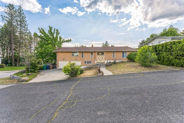 4004 W Taft Dr, Spokane, WA 99208 - view of front of home featuring driveway, an attached garage, and brick siding