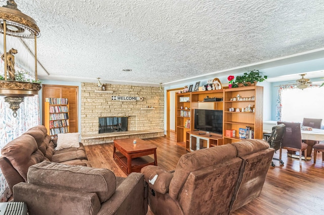4004 W Taft Dr, Spokane, WA 99208 - living area with a textured ceiling, wood finished floors, a fireplace, crown molding, and ceiling fan