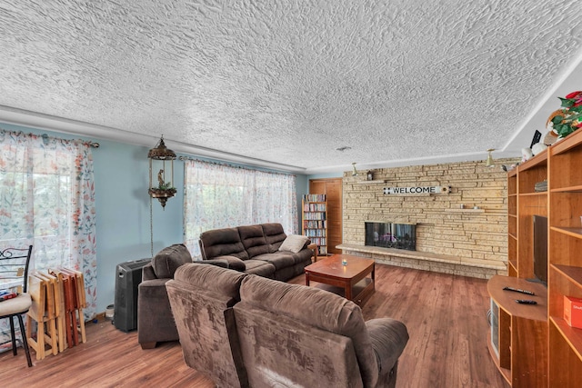 4004 W Taft Dr, Spokane, WA 99208 - living area with wood finished floors, a stone fireplace, and a textured ceiling