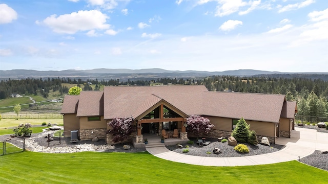 16510 N Brannon Ln, Spokane, WA 99208 - view of front of house with stone siding, a mountain view, a front yard, and cooling unit