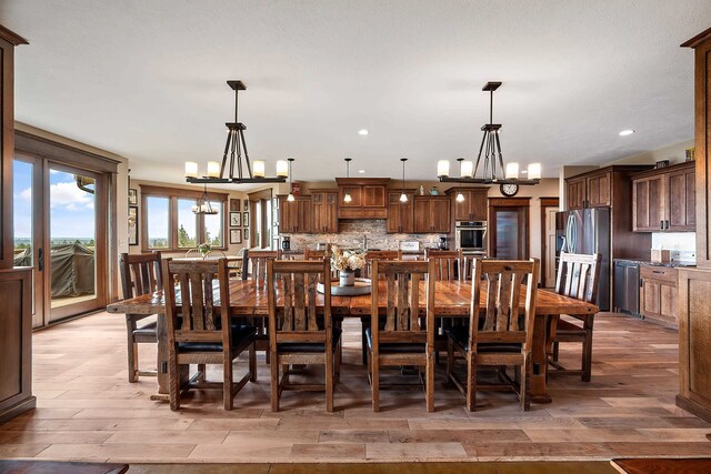 16510 N Brannon Ln, Spokane, WA 99208 - dining room with a chandelier, light wood-style flooring, and recessed lighting