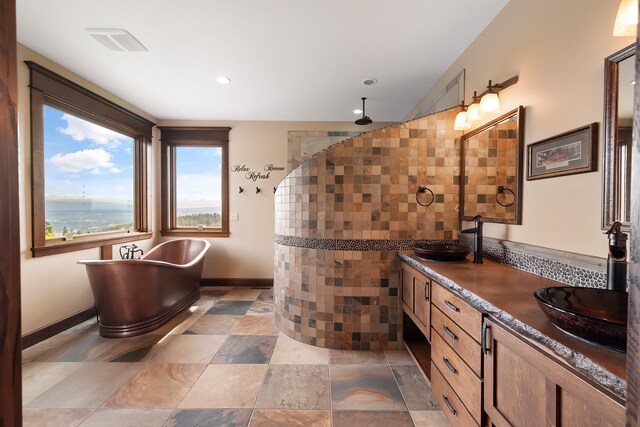 16510 N Brannon Ln, Spokane, WA 99208 - bathroom with a freestanding tub, double vanity, tiled shower, baseboards, and recessed lighting