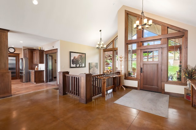 16510 N Brannon Ln, Spokane, WA 99208 - entrance foyer with a chandelier, baseboards, high vaulted ceiling, concrete floors, and recessed lighting
