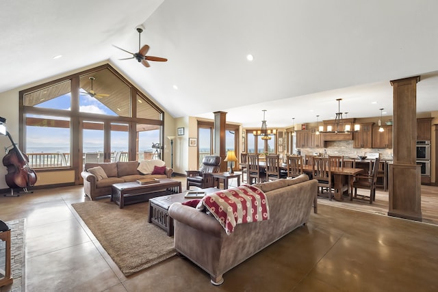 16510 N Brannon Ln, Spokane, WA 99208 - living room with decorative columns, a ceiling fan, concrete floors, recessed lighting, and a chandelier