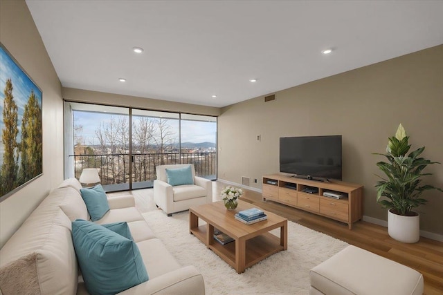 700 W 7th Ave # 206, Spokane, WA 99204 - living room featuring wood finished floors, baseboards, and recessed lighting