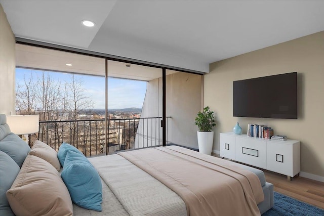 700 W 7th Ave # 206, Spokane, WA 99204 - bedroom with wood finished floors, floor to ceiling windows, baseboards, access to outside, and recessed lighting