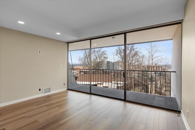 700 W 7th Ave # 206, Spokane, WA 99204 - empty room featuring wood finished floors, baseboards, and recessed lighting