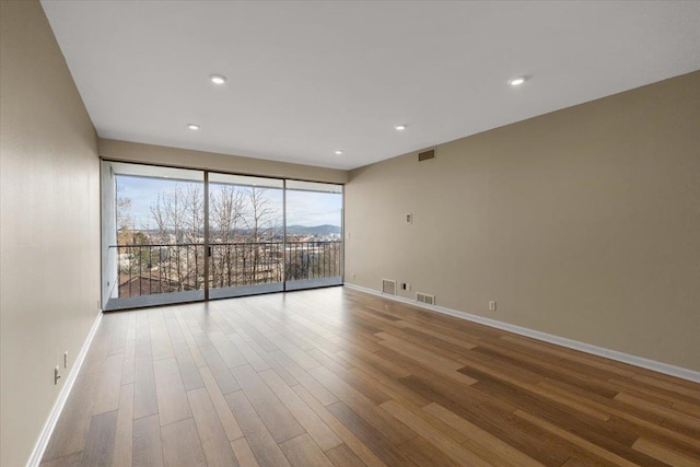 700 W 7th Ave # 206, Spokane, WA 99204 - unfurnished room featuring wood finished floors, baseboards, and recessed lighting