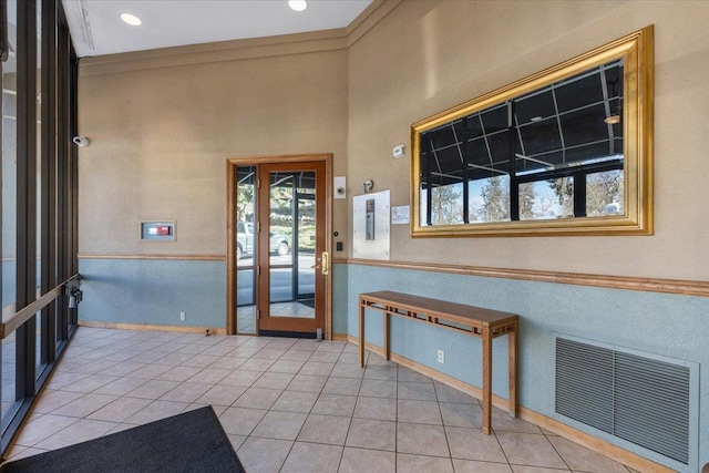 700 W 7th Ave # 206, Spokane, WA 99204 - entrance foyer with baseboards, light tile patterned flooring, and ornamental molding