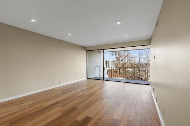 700 W 7th Ave # 206, Spokane, WA 99204 - spare room with baseboards, wood finished floors, and recessed lighting