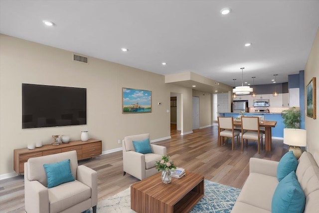 700 W 7th Ave # 206, Spokane, WA 99204 - living room featuring light wood-type flooring, baseboards, and recessed lighting