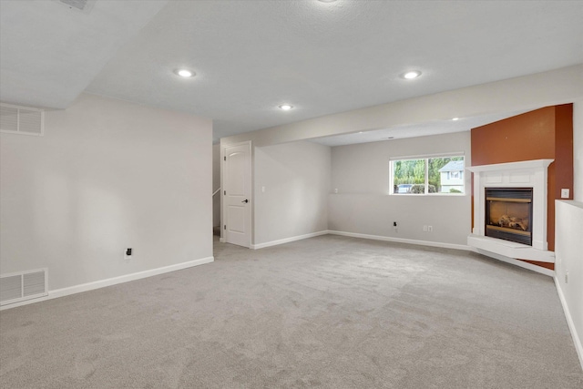 18920 E Augusta Ln, Spokane Valley, WA 99016 - unfurnished living room featuring recessed lighting, baseboards, carpet flooring, and a fireplace with raised hearth