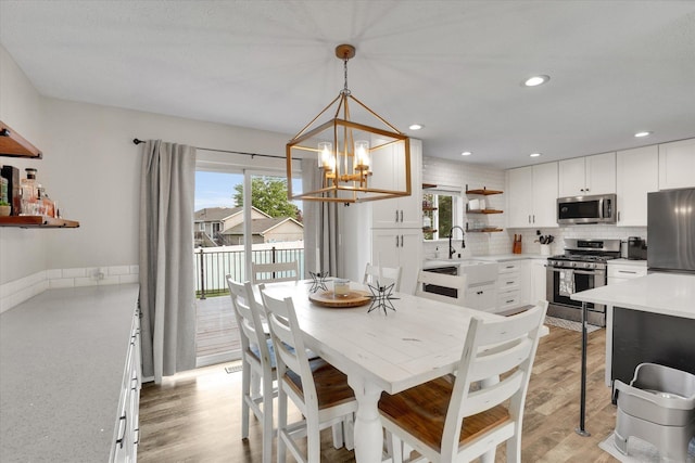 18920 E Augusta Ln, Spokane Valley, WA 99016 - dining space featuring a chandelier, light wood-type flooring, and recessed lighting