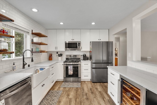 18920 E Augusta Ln, Spokane Valley, WA 99016 - kitchen featuring appliances with stainless steel finishes, wine cooler, open shelves, tasteful backsplash, and light countertops