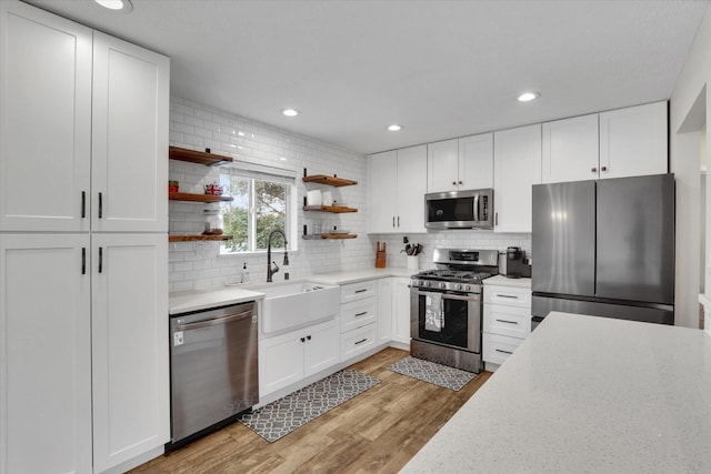 18920 E Augusta Ln, Spokane Valley, WA 99016 - kitchen featuring stainless steel appliances, a sink, open shelves, decorative backsplash, and recessed lighting