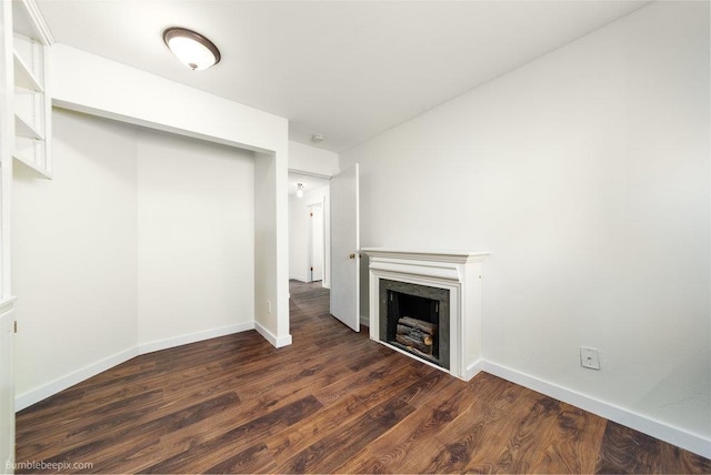 707 W 6th Ave Unit 41, Spokane, WA 99204 - unfurnished living room with a high end fireplace, dark wood finished floors, and baseboards