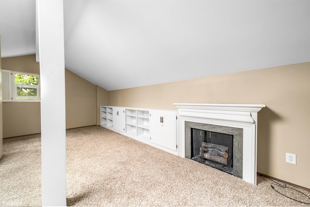 707 W 6th Ave Unit 41, Spokane, WA 99204 - unfurnished living room with vaulted ceiling, carpet floors, and a fireplace
