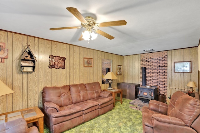 3970 Cedar Bay Rd, Loon Lake, WA 99148 - carpeted living area featuring a wood stove, wood walls, and ceiling fan