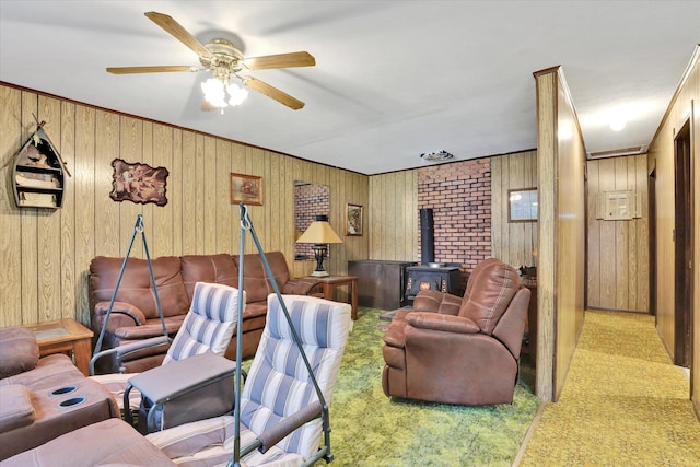 3970 Cedar Bay Rd, Loon Lake, WA 99148 - carpeted living room with a wood stove, ceiling fan, and wood walls