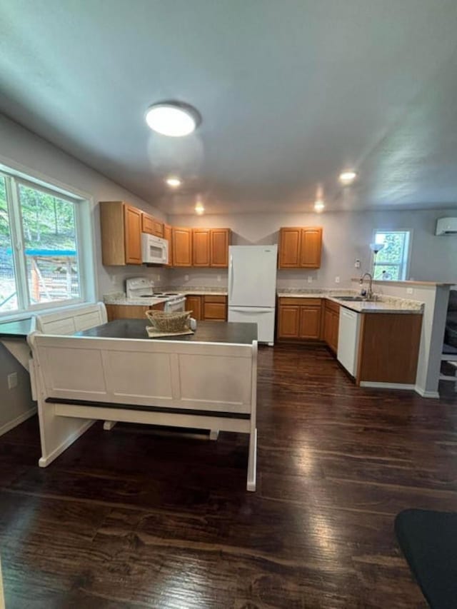 1108 Basin Rd, Colville, WA 99114 - kitchen featuring white appliances, a peninsula, dark wood finished floors, recessed lighting, and a sink