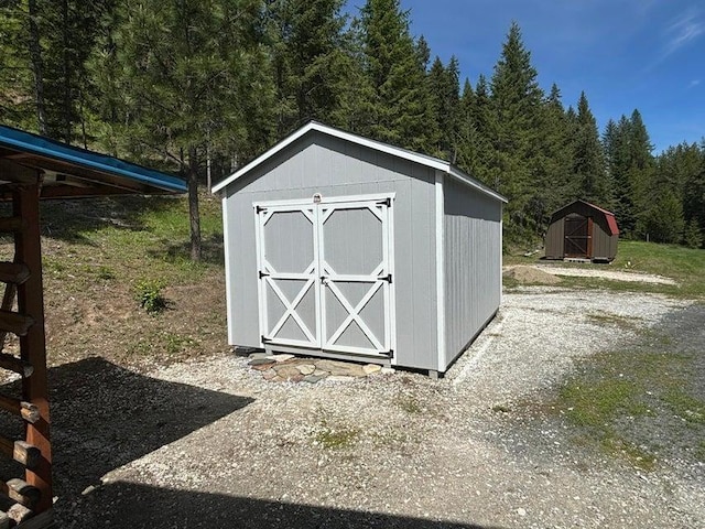 1108 Basin Rd, Colville, WA 99114 - view of shed featuring a view of trees