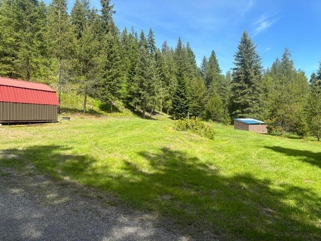 1108 Basin Rd, Colville, WA 99114 - view of grassy yard featuring a wooded view