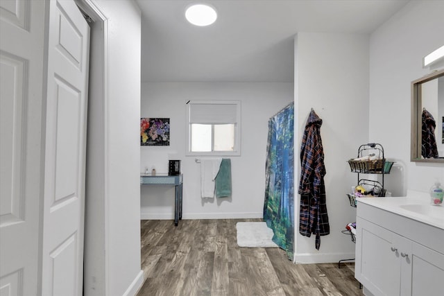 228 W Poplar St, Tekoa, WA 99033 - bathroom featuring vanity, wood finished floors, and baseboards