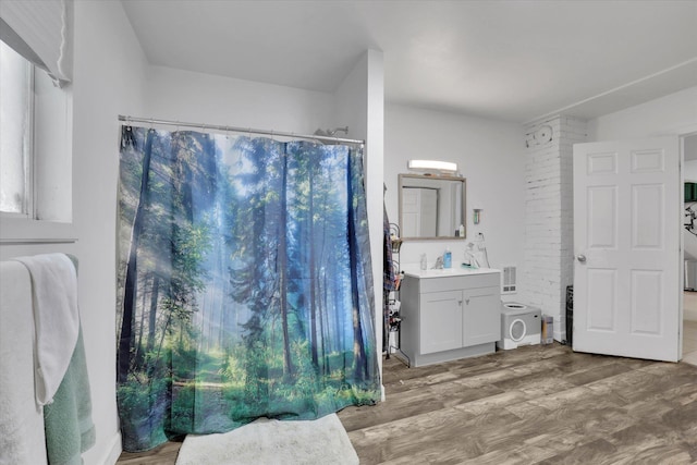 228 W Poplar St, Tekoa, WA 99033 - full bathroom featuring vanity, wood finished floors, and curtained shower
