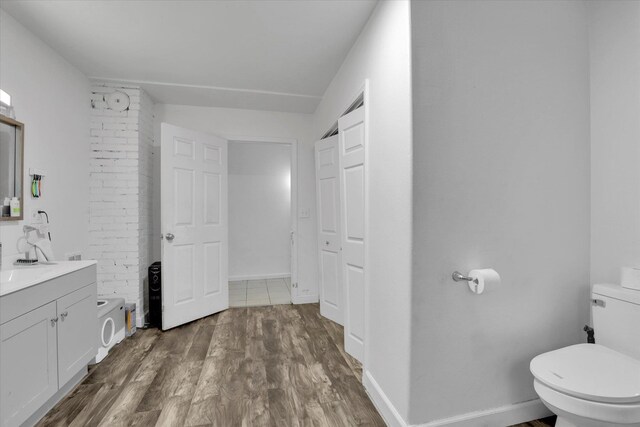 228 W Poplar St, Tekoa, WA 99033 - bathroom with toilet, vanity, wood finished floors, baseboards, and a shower