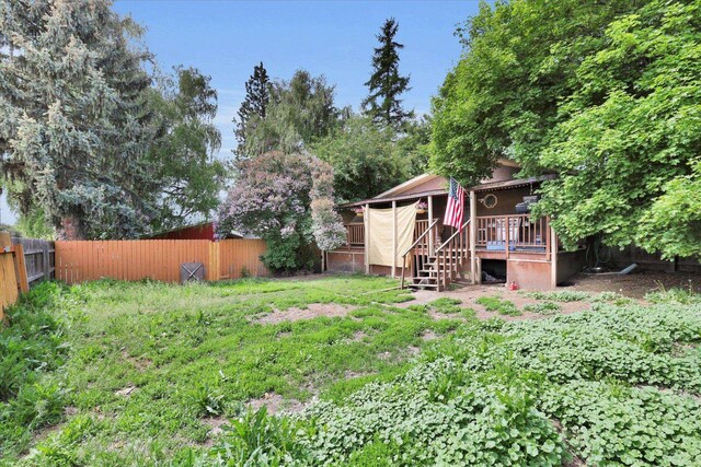 228 W Poplar St, Tekoa, WA 99033 - fenced backyard featuring stairway and a wooden deck