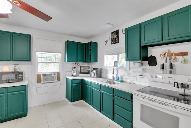228 W Poplar St, Tekoa, WA 99033 - kitchen with white electric range oven, black microwave, cooling unit, a sink, and light countertops