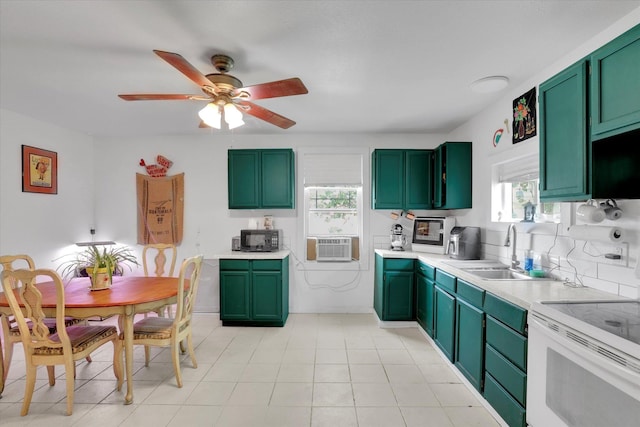 228 W Poplar St, Tekoa, WA 99033 - kitchen with green cabinets, a sink, black microwave, and light countertops