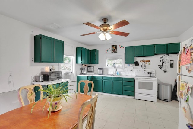 228 W Poplar St, Tekoa, WA 99033 - kitchen featuring white appliances, green cabinets, a ceiling fan, a sink, and light countertops