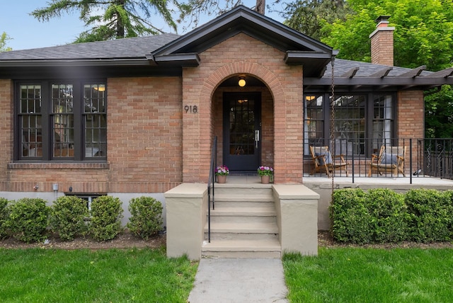 918 W 18th Ave, Spokane, WA 99203 - entrance to property with brick siding, a shingled roof, and a chimney