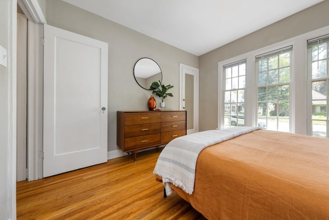 918 W 18th Ave, Spokane, WA 99203 - bedroom with multiple windows, light wood-type flooring, and baseboards