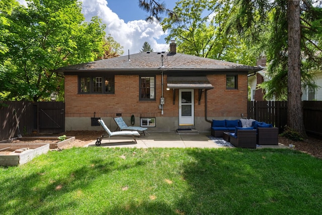 918 W 18th Ave, Spokane, WA 99203 - back of property featuring a garden, an outdoor hangout area, a patio, a chimney, and brick siding