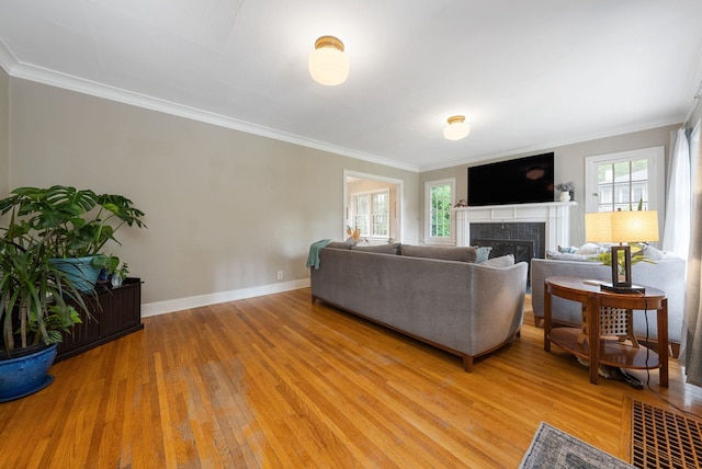 918 W 18th Ave, Spokane, WA 99203 - living area with plenty of natural light, light wood-style floors, ornamental molding, baseboards, and a fireplace