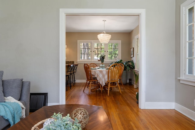 918 W 18th Ave, Spokane, WA 99203 - dining area with a chandelier, wood finished floors, and baseboards