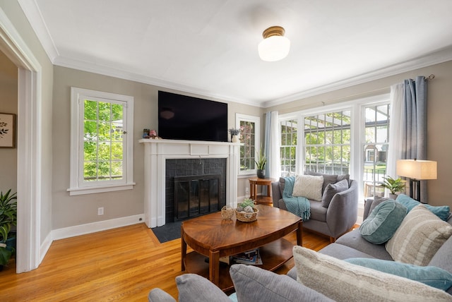 918 W 18th Ave, Spokane, WA 99203 - living room featuring a tile fireplace, ornamental molding, baseboards, and light wood-type flooring