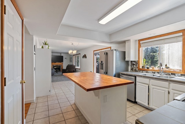 11510 E 20th Ave, Spokane Valley, WA 99206 - kitchen with appliances with stainless steel finishes, wooden counters, a sink, white cabinets, and light tile patterned floors