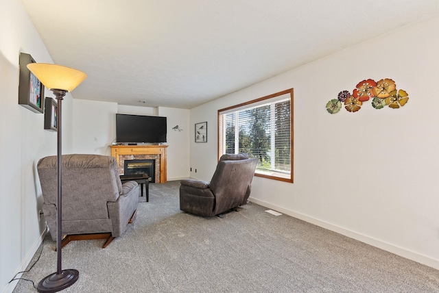 11510 E 20th Ave, Spokane Valley, WA 99206 - carpeted living area featuring a tiled fireplace and baseboards